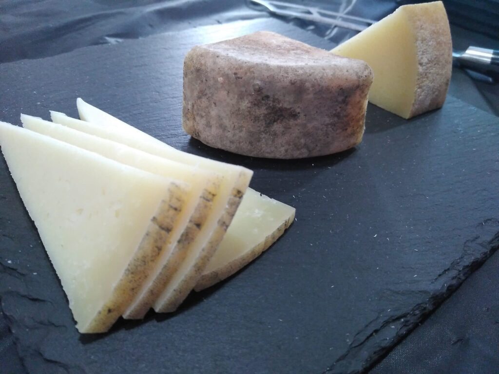 Tabla de quesos artesanales de la Sierra de Francia: queso fresco rebanado y queso curado con costra rústica.